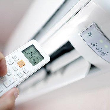 an hvac technician programming a multi-split unit of an ac system