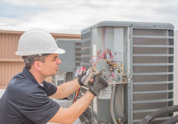 a HVC technician in grey shirt on a heating and air service