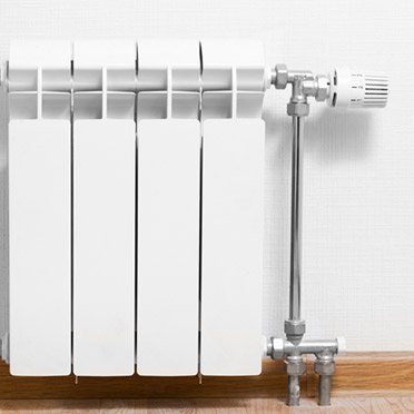 a white wall mounted radiator as part of a home heating system